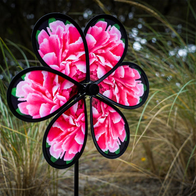 13.5 inch Peony Spinner with realistic printed petals and green leaves spinning in a charming outdoor garden setting.