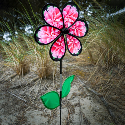 13.5 inch Peony Spinner with realistic printed petals and green leaves spinning in a charming outdoor garden setting.