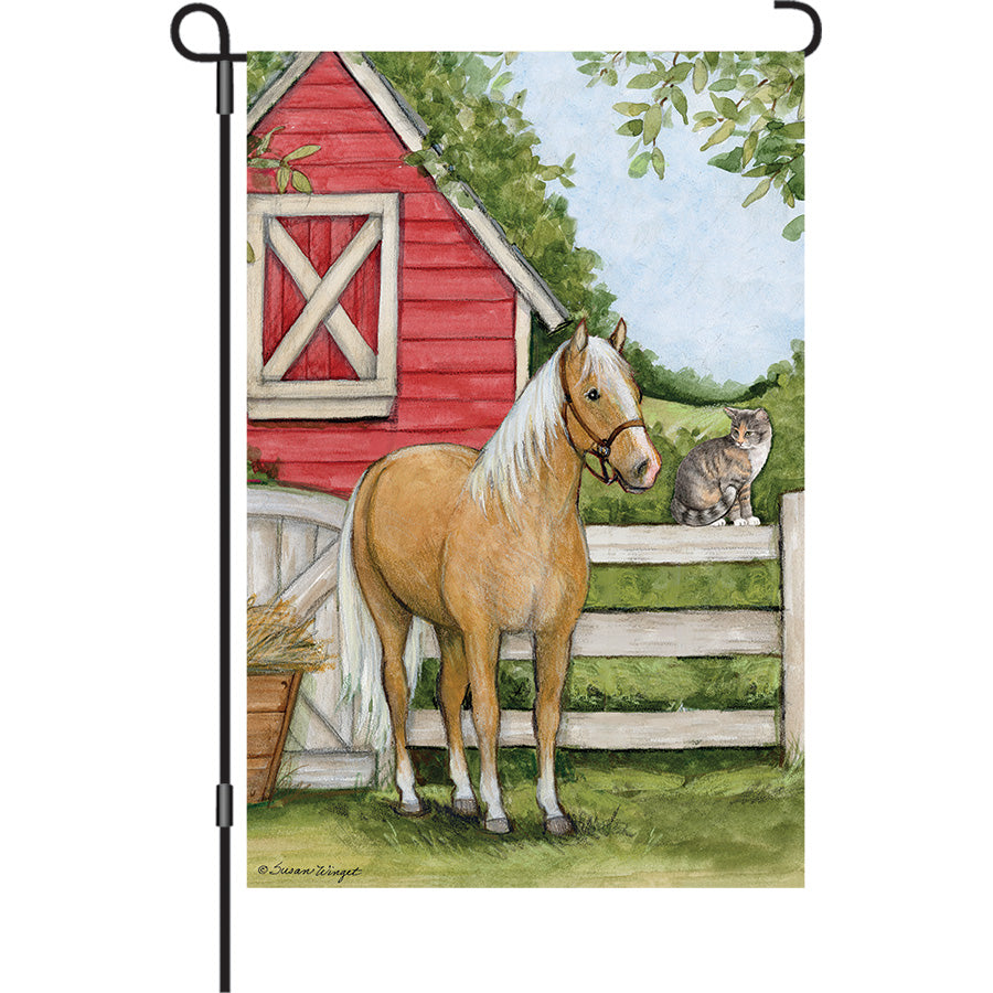 13 in. Elite Oversized Garden Flag featuring a vibrant Palomino horse design displayed on a standard garden flag pole in a colorful flower garden.