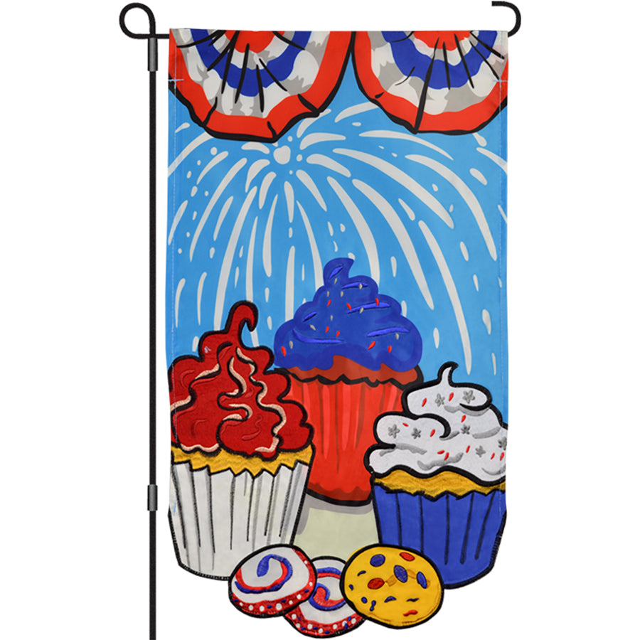 13 in. Enhanced Flag - Patriotic Cupcake, embroidered garden flag with colorful designs displayed on a garden pole in a bright outdoor setting.