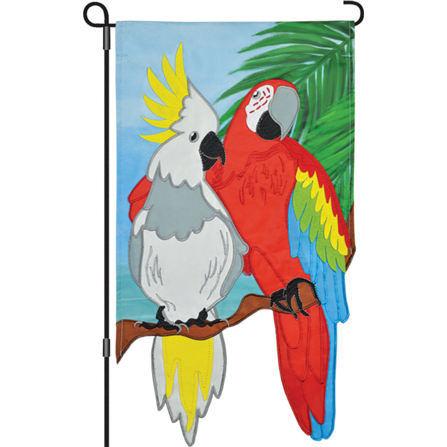 13 in. Enhanced Flag - Tropical Friends showcasing a colorful macaw and cockatoo duo in a garden setting, perfect for outdoor display.