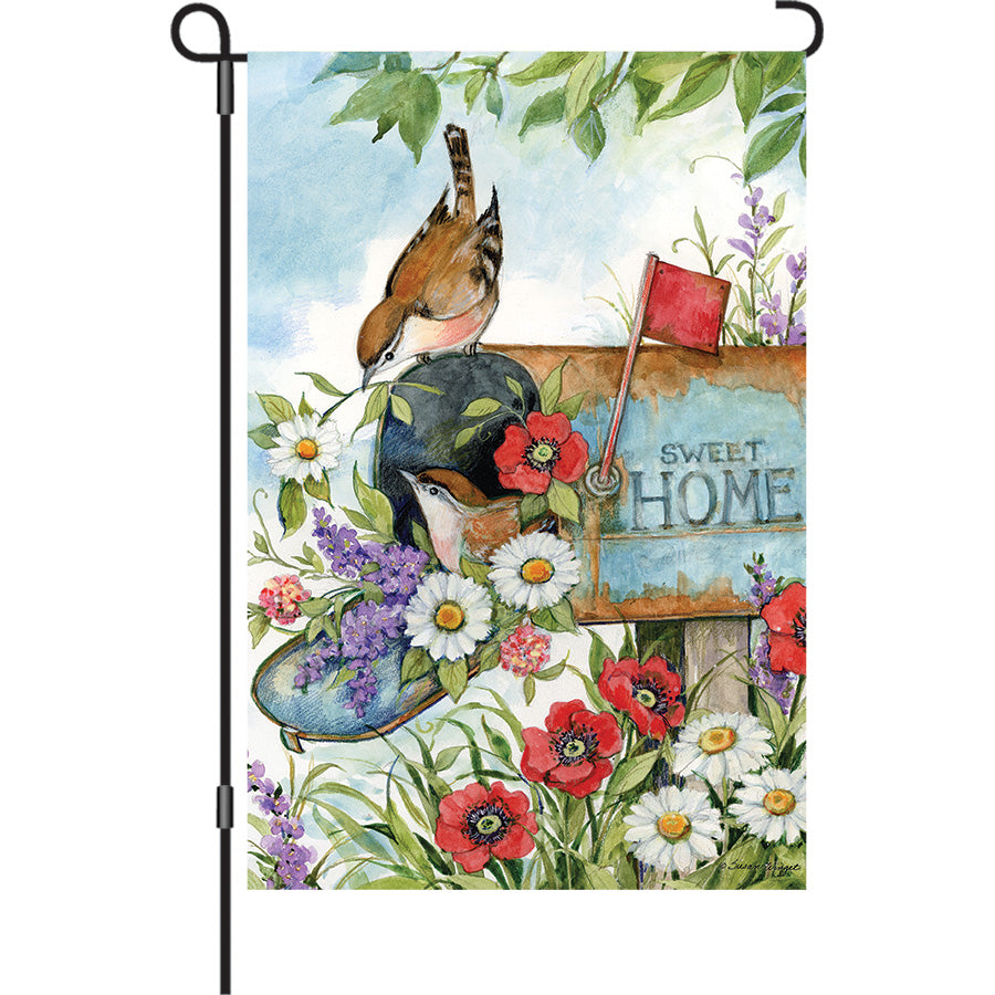13 in. Elite Oversized Garden Flag featuring Birds in the Mailbox design, displayed on a garden pole, adding color to a patio setting.