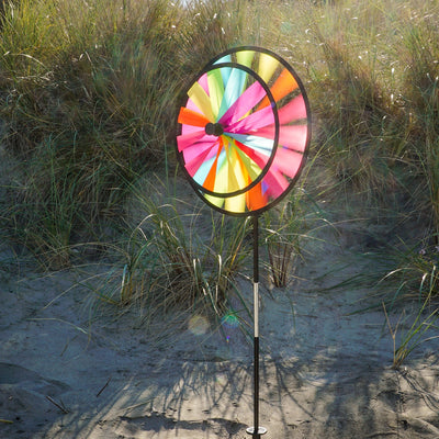 13-inch Fiesta Double Spinner with Wind Sail showcasing vibrant colors and dual spinning wheels, placed in a garden setting.
