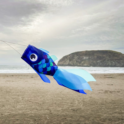 15-inch Cool Damsel Fish windsock featuring vibrant colors, gracefully fluttering in the breeze on a garden pole.