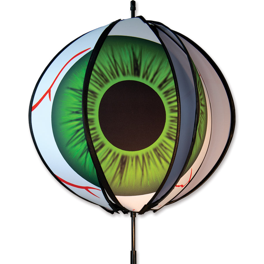 15 in. Ball Spinner with six colorful bloodshot eyeball panels set up in a garden, showcasing its playful spinning feature.