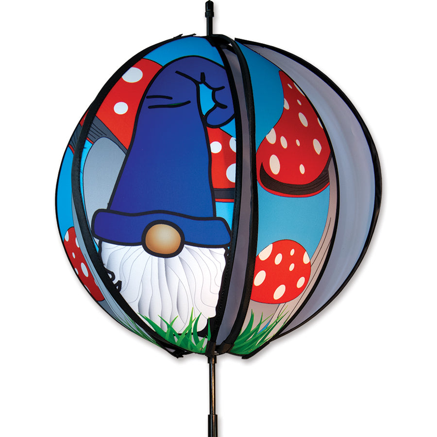 15 in. Ball Spinner with colorful gnome and mushroom designs, spinning in the breeze on a garden stake in a lush outdoor setting.