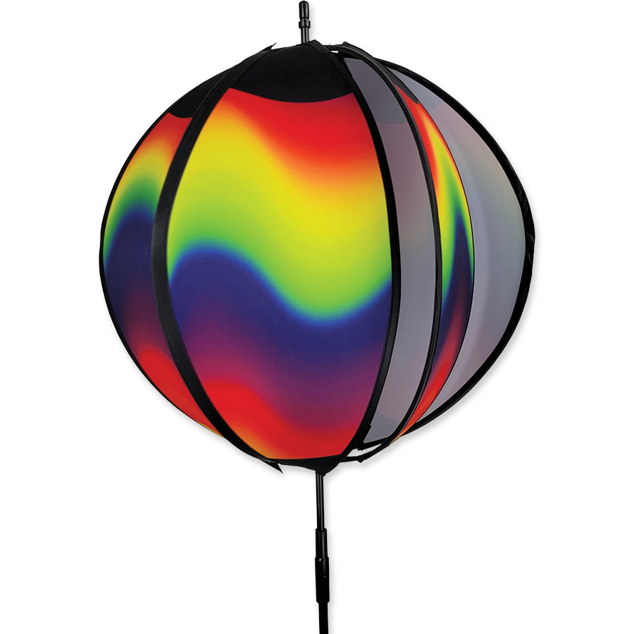15 in. Ball Spinner featuring a wavy gradient pattern, designed for outdoor display, spins gracefully under breezy conditions.