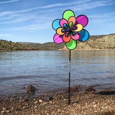 Brightly colored 15\" Neon Windee Wheelz and Flower Spinner in a garden setting, showcasing an animated flower design and spinning wheel.