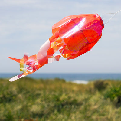 15-inch Orange Iridescent Jellyfish 3D Windsock swaying in the breeze, showcasing vivid colors and realistic jellyfish design.