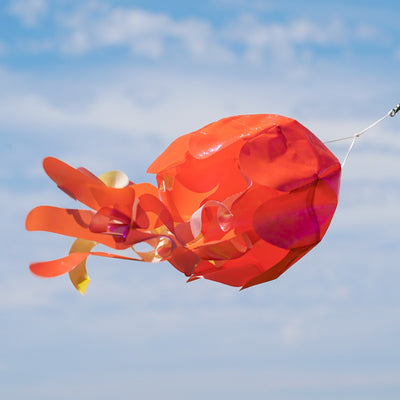 15-inch Orange Iridescent Jellyfish 3D Windsock swaying in the breeze, showcasing vivid colors and realistic jellyfish design.