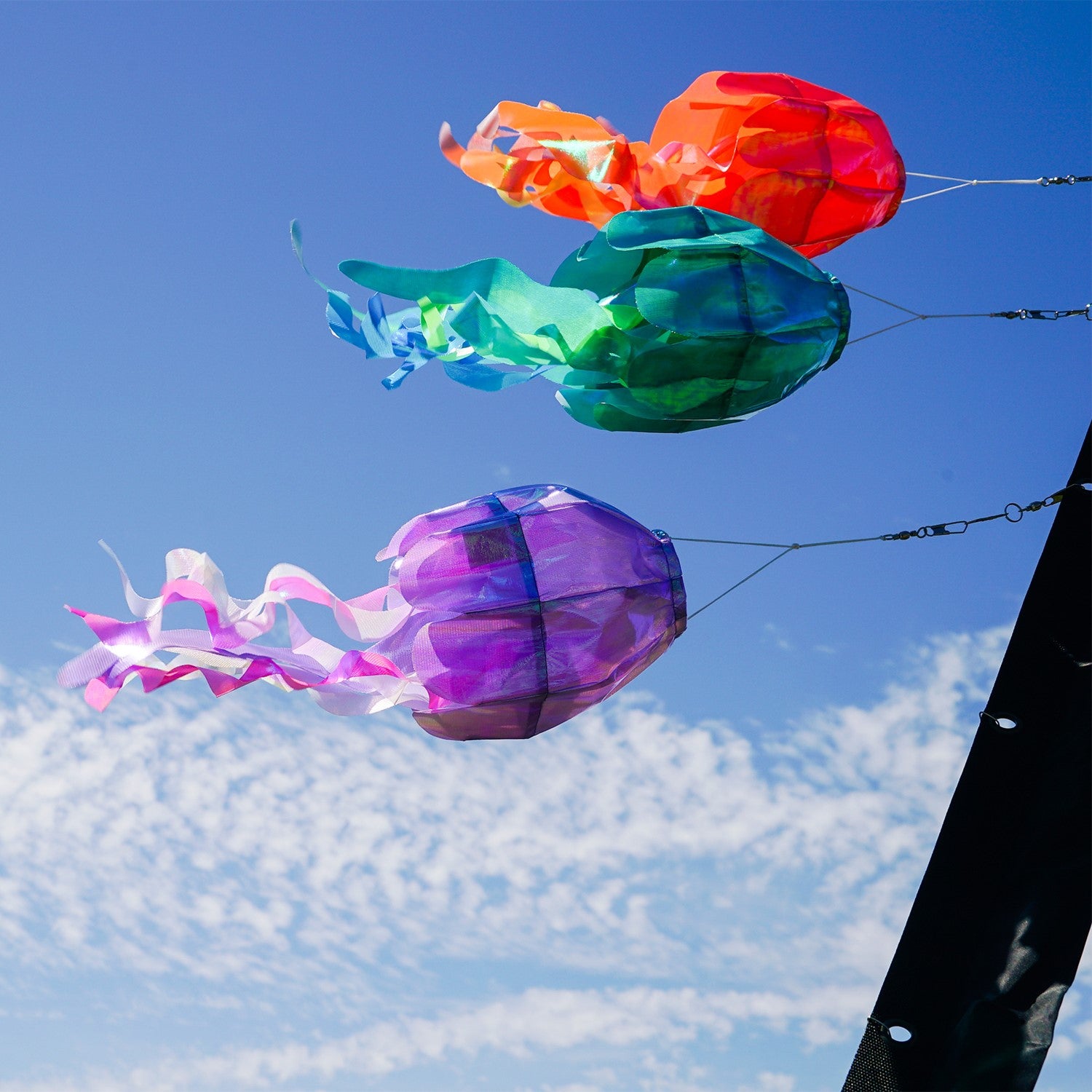 15-inch Orange Iridescent Jellyfish 3D Windsock swaying in the breeze, showcasing vivid colors and realistic jellyfish design.