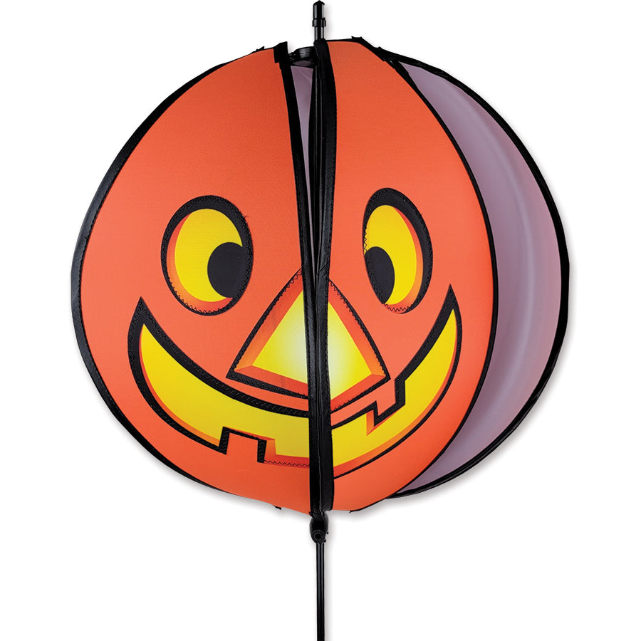 15-inch Pumpkin Spinning Head featuring a happy face on one side and a spooky face on the other, beautifully displayed outdoors.