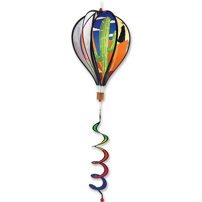 Vibrant 16 in. Hot Air Balloon in Southwestern design spinning gracefully outdoors with colorful twister tail in a garden setting.