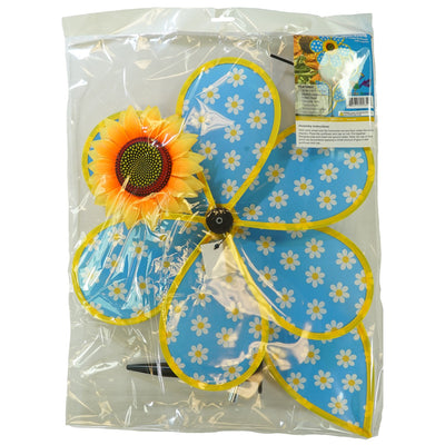 Colorful 16-inch Daisy Sunflower with Leaves spinner featuring polka dot petals and a realistic sunflower center, displayed outdoors in a garden setting.