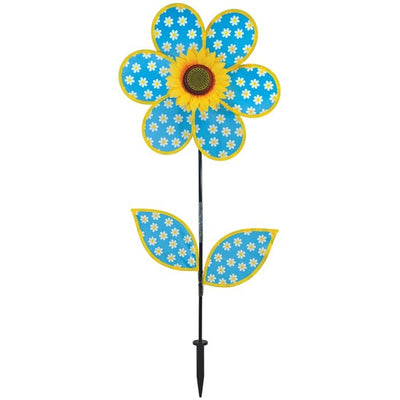 Colorful 16-inch Daisy Sunflower with Leaves spinner featuring polka dot petals and a realistic sunflower center, displayed outdoors in a garden setting.