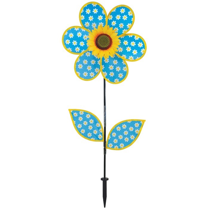 Colorful 16-inch Daisy Sunflower with Leaves spinner featuring polka dot petals and a realistic sunflower center, displayed outdoors in a garden setting.