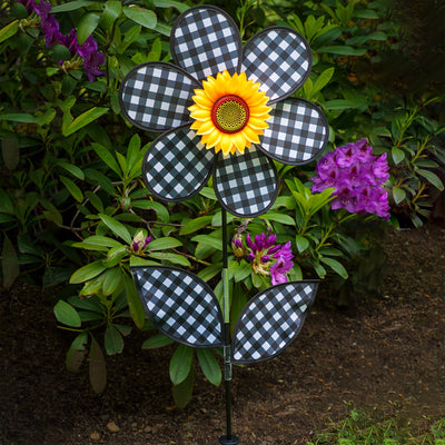 16-inch Gingham Flower with Leaves garden spinner with black gingham petals and leaves, rotating gently in the breeze on a pole.
