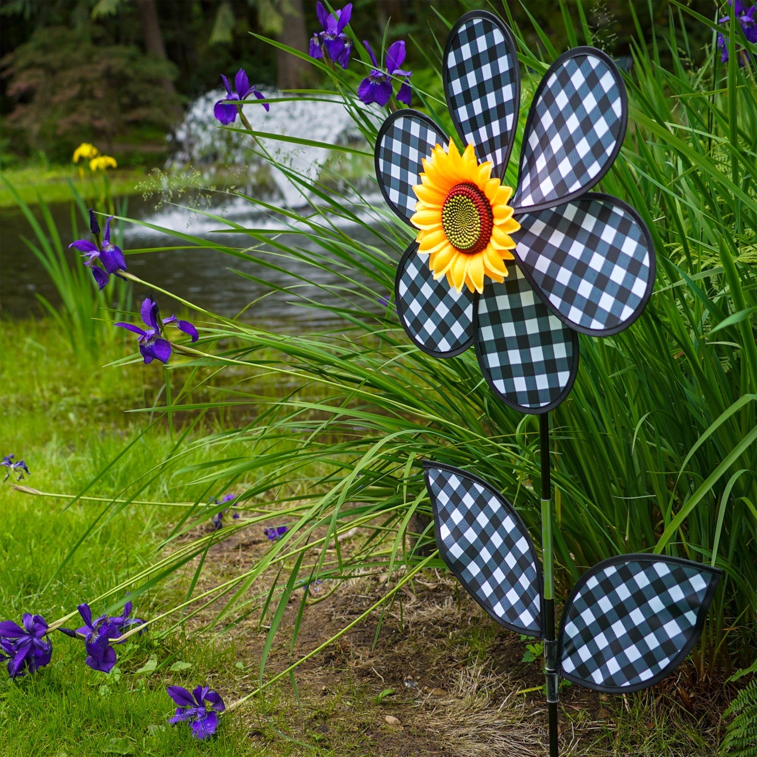 16-inch Gingham Flower with Leaves garden spinner with black gingham petals and leaves, rotating gently in the breeze on a pole.