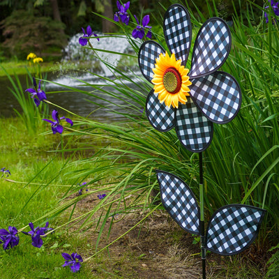 16-inch Gingham Flower with Leaves garden spinner with black gingham petals and leaves, rotating gently in the breeze on a pole.