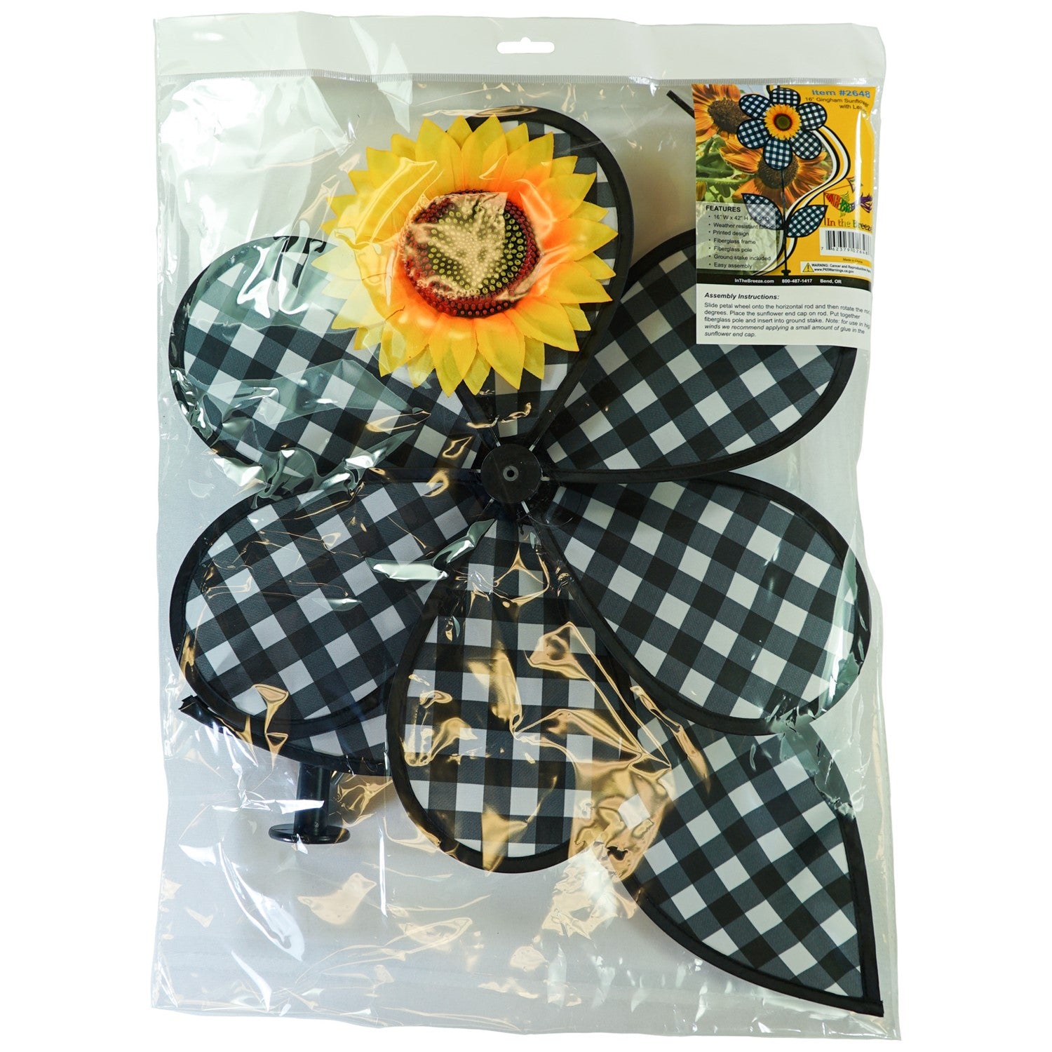 16-inch Gingham Flower with Leaves garden spinner with black gingham petals and leaves, rotating gently in the breeze on a pole.
