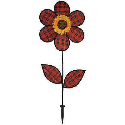 A vibrant 16-inch Red Plaid Flower Spinner with lush green leaves and a sunflower center, rotating gracefully in a garden setting.