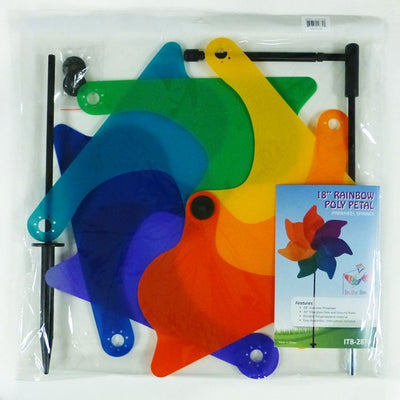 A vibrant 18\" Rainbow Poly Petal Spinner showing colorful petals spinning in the breeze, mounted on a two-section fiberglass pole in a garden setting.