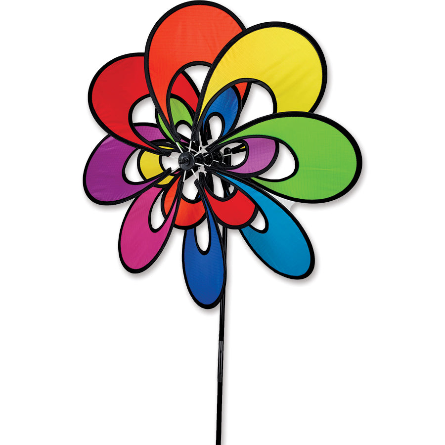 19 in. Double Whirly Spinner - Rainbow, showcasing vibrant petals spinning beautifully in the breeze in a garden setting.