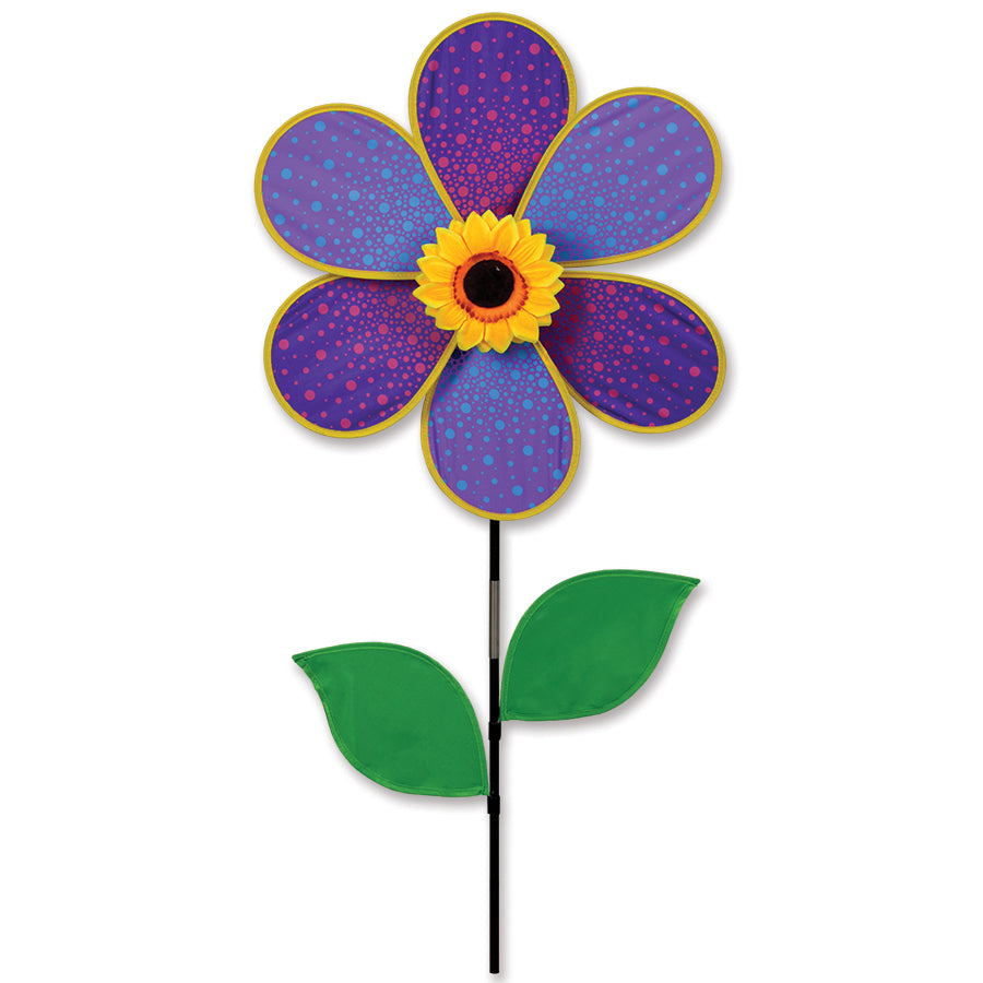 19 in. Flower Spinner featuring a purple sunflower design rotating gracefully in a garden setting on a sunny day.
