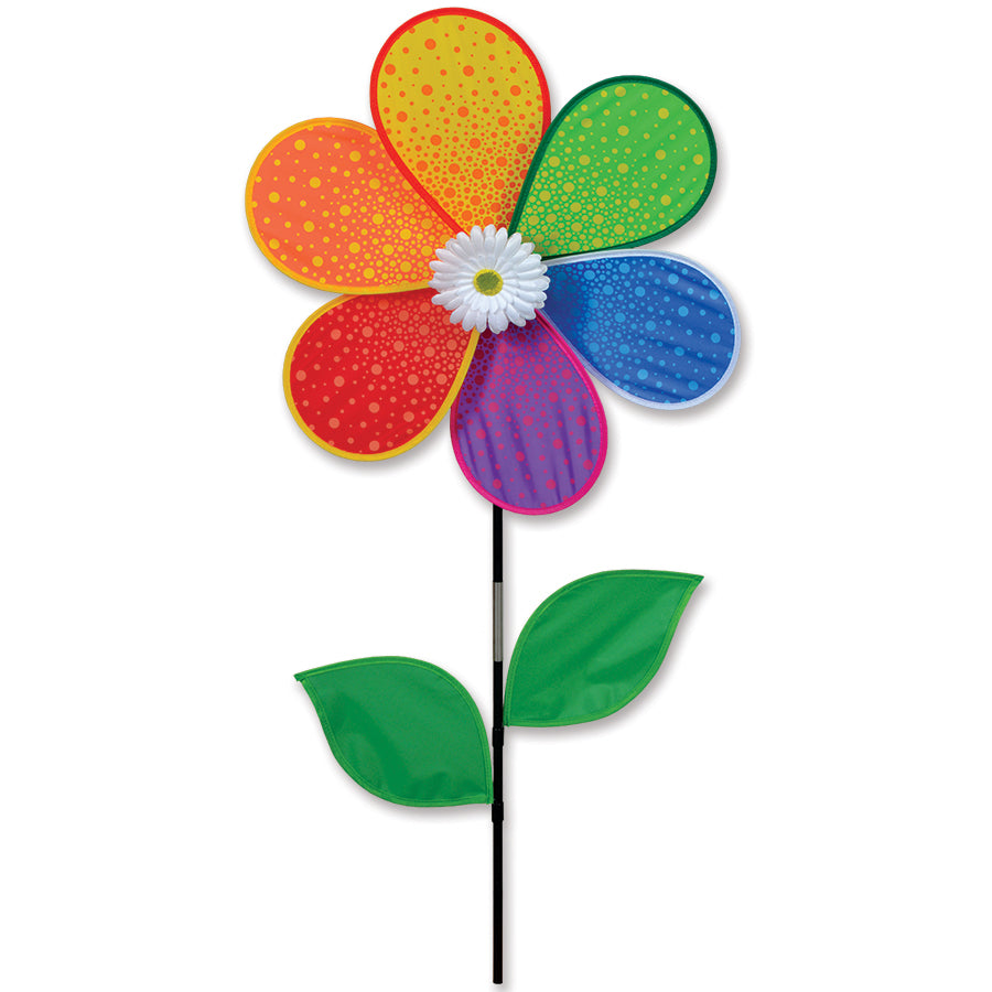 19 in. flower spinner featuring a white daisy design rotating gently in the breeze in a vibrant garden setting.