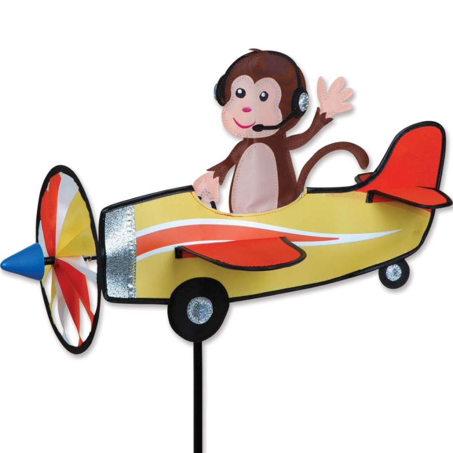 19 in. Pilot Pal Spinner featuring a cheerful monkey design, spinning in the wind, adding a fun element to an outdoor garden setting.