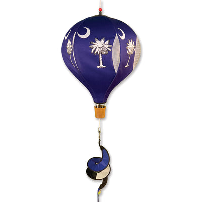 19 in. Pop-Open Hot Air Balloon displayed outdoors, spinning gracefully in the wind, showcasing its vibrant colors and design.