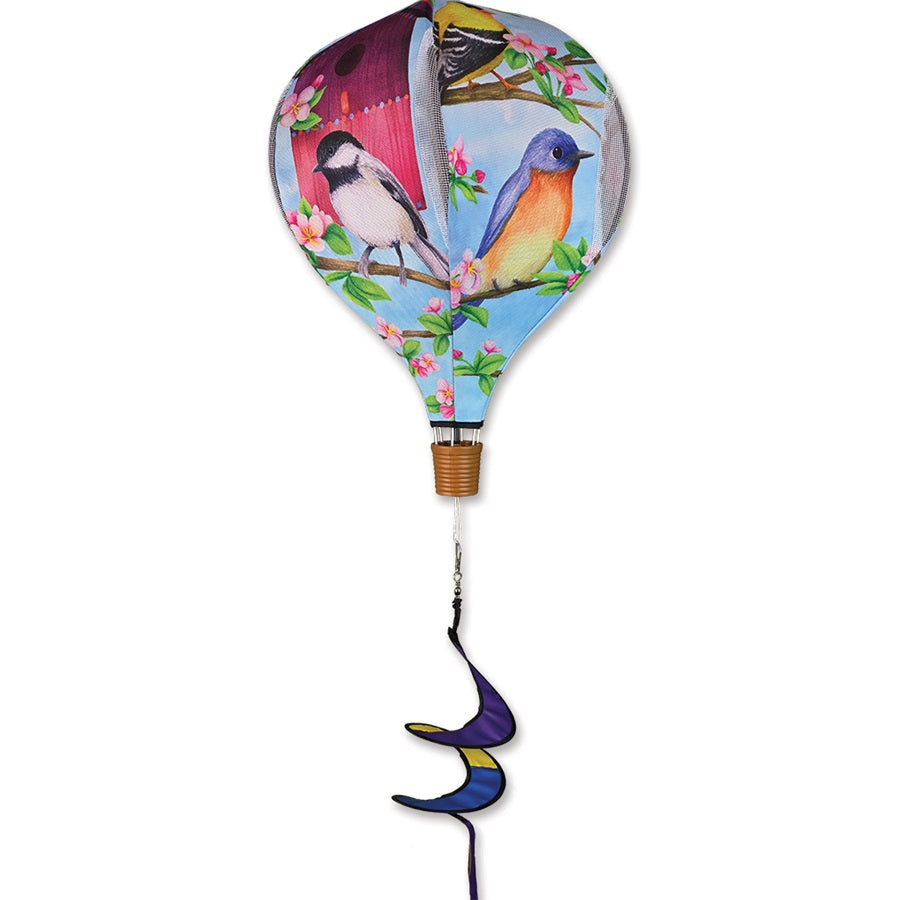 Colorful 19 in. Pop-Open Hot Air Balloon wind spinner displayed in a garden setting, spinning gently in the breeze.