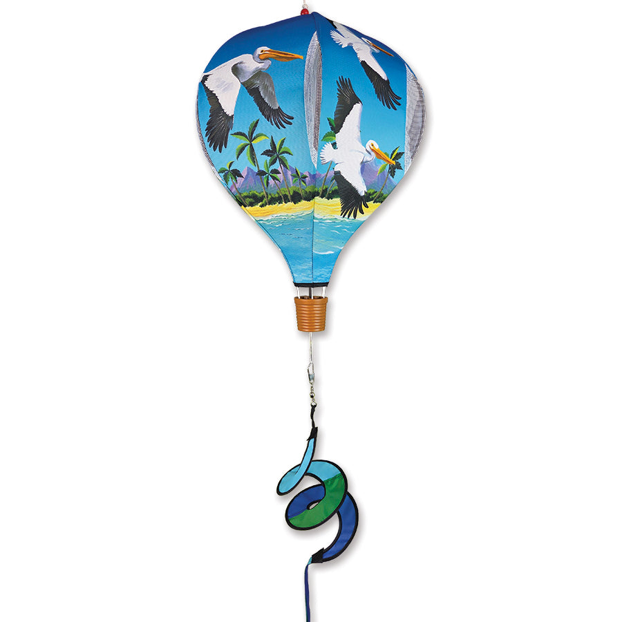 Vibrant 19 in. Pop-Open Hot Air Balloon featuring pelican design spinning gently in the wind on a garden deck, showcasing outdoor charm.