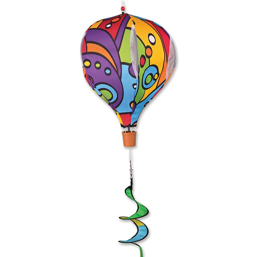19 in. Pop-Open Hot Air Balloon in Rainbow Orbit design displayed outdoors, featuring a colorful spinning design against a garden backdrop.