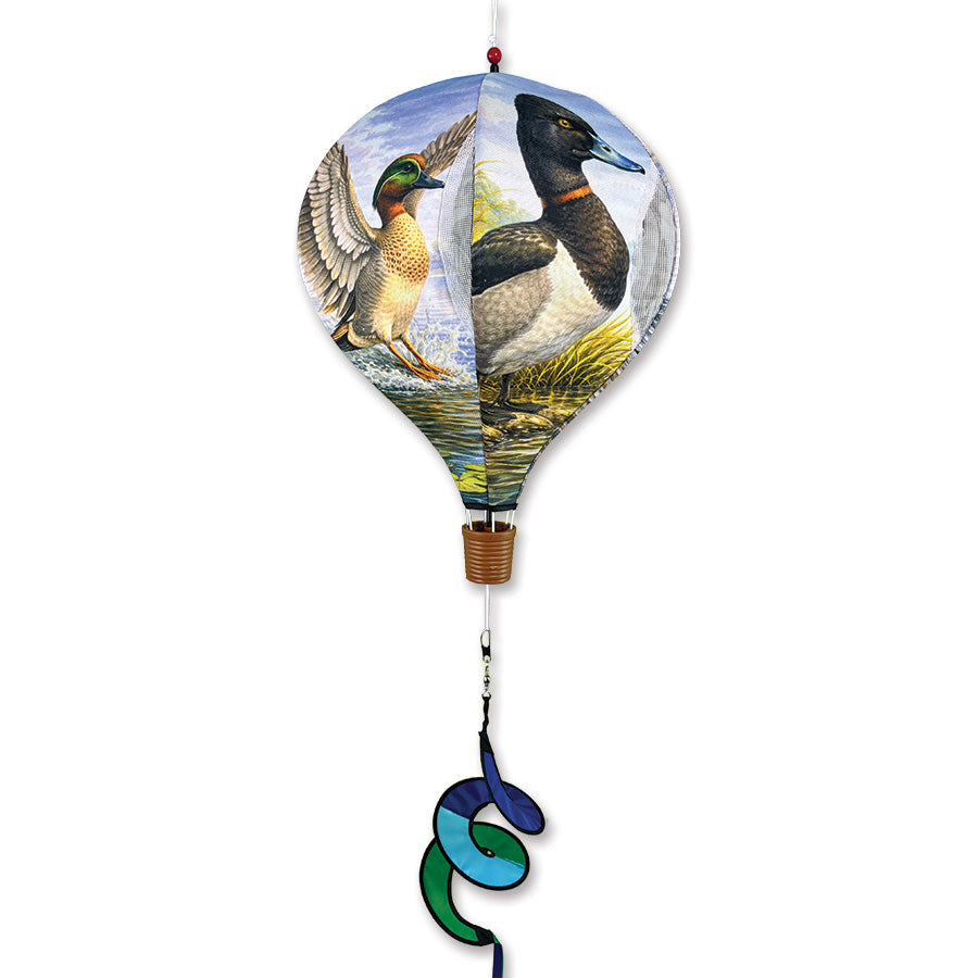 19 in. Pop-Open Hot Air Balloon featuring Southern Ducks design spinning in the wind on a garden deck, showcasing bright colors and easy assembly.