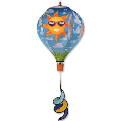 19 in. Pop-Open Hot Air Balloon spinning in the wind, featuring bright summer colors and designs, showcased in a garden setting.