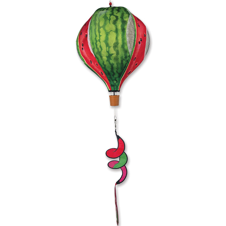 Vibrant 19 in. Pop-Open Hot Air Balloon in Watermelon design displayed in a garden setting, spinning gently in the breeze.