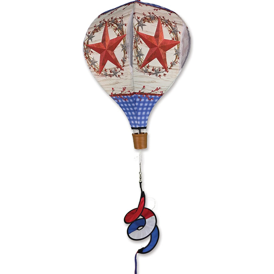 Vibrant 19 in. Pop-Open Hot Air Balloon wind spinner in a garden setting, showcasing its colorful fabric and effortless assembly feature.