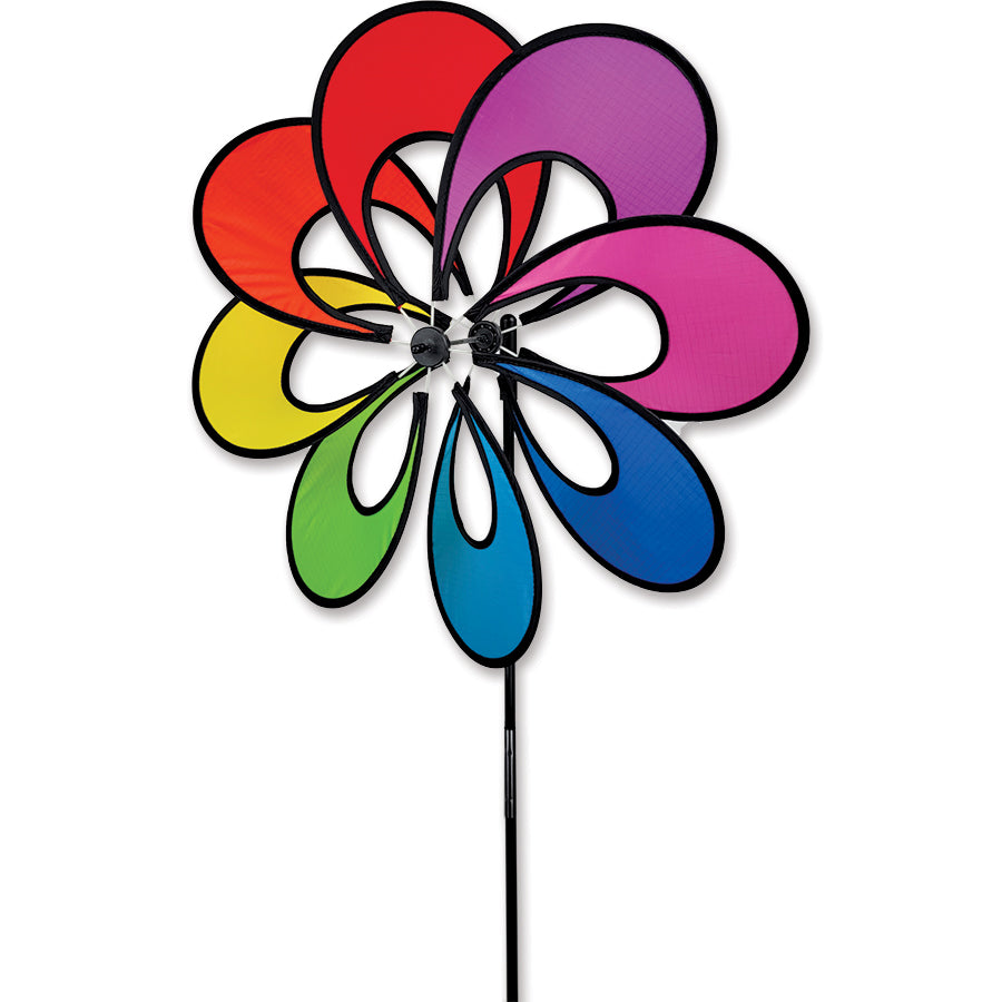 19 in. Single Whirly Spinner - Rainbow with colorful spinning petals displayed in a garden, adding lively movement and brightness to outdoor decor.
