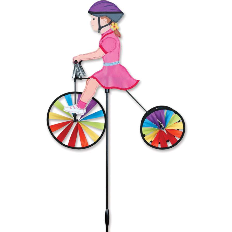 Colorful 19 in. Tricycle Spinner with shiny silver tassels on the handlebars, spinning joyfully in an outdoor garden setting.