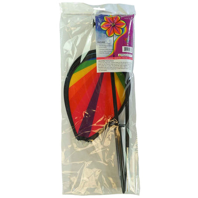 19-inch Rainbow Star Flower Spinner with colorful striped petals spinning in the breeze, displayed in a garden setting.
