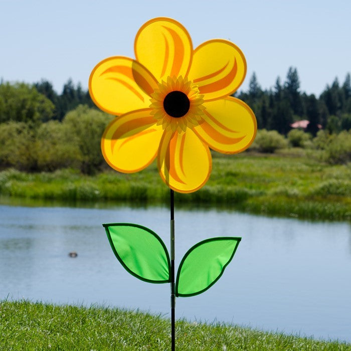 19-inch sunflower garden spinner with six bright yellow petals and two leaves on a fiberglass stem, elegantly rotating outdoors.