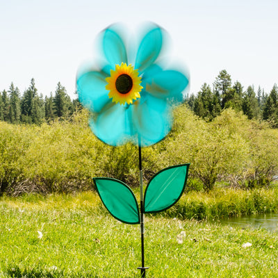 19-inch teal sunflower spinner featuring six petals and green leaves, rotating in a garden setting with a bright blue sky background.