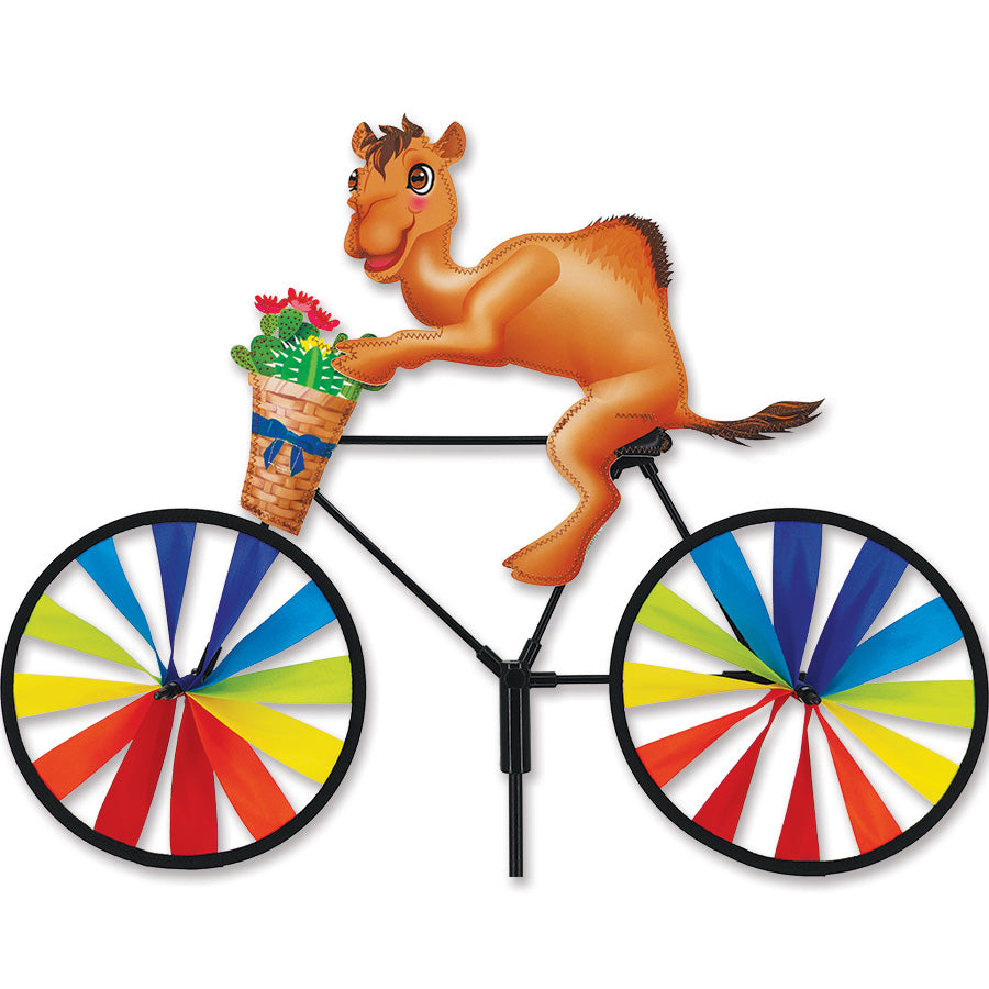 20 in. Bike Spinner featuring a vibrant camel design, spinning in the breeze in a colorful garden setting.