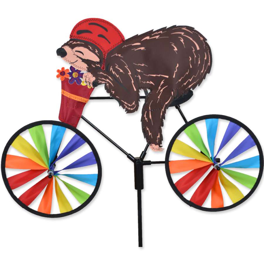 20 in. Bike Spinner featuring a colorful sloth design spinning gently on a garden stake in a sunny outdoor setting.