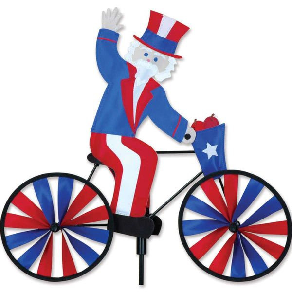 20 In Bike Spinner displaying Uncle Sam design, made from colorful SunTex fabric, spinning in the breeze in an outdoor garden setting.