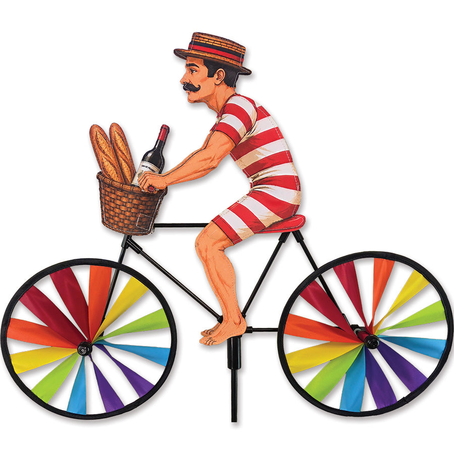 20 in. Bike Spinner featuring a Victorian Man with a basket of baguettes and wine, elegantly spinning outdoors in a garden setting.