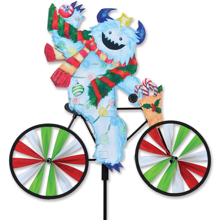 20 in. Bike Spinner - Yeti showcasing a colorful Yeti design, spinning in the breeze in a bright garden setting.