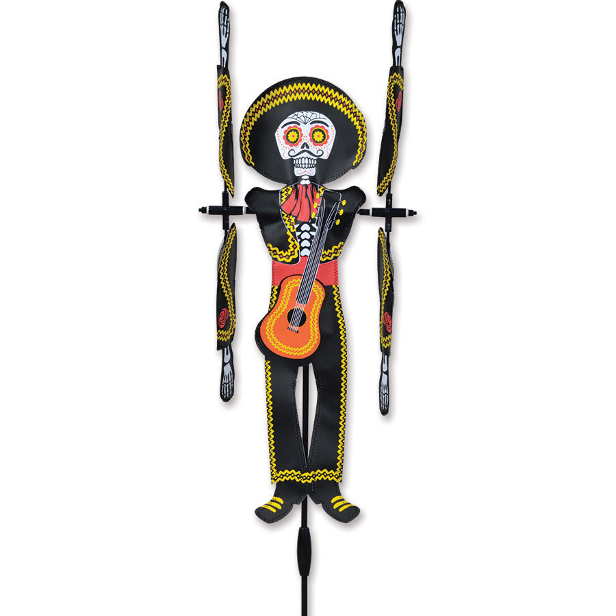 20 in. WhirliGig Spinner featuring a Day of the Dead Man design with colorful patterns shown spinning in a garden setting.