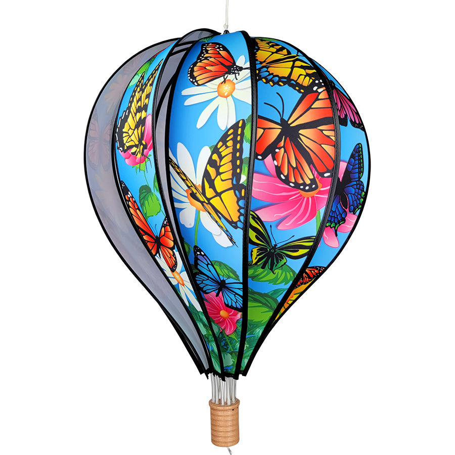 22 in. Hot Air Balloon with vibrant butterflies design, hanging outdoors and spinning gently in the breeze, adding charm and color to the garden.